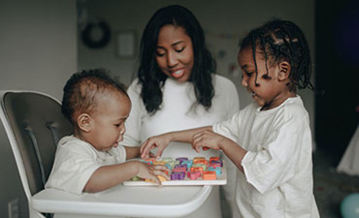 Young child playing with younger sibling